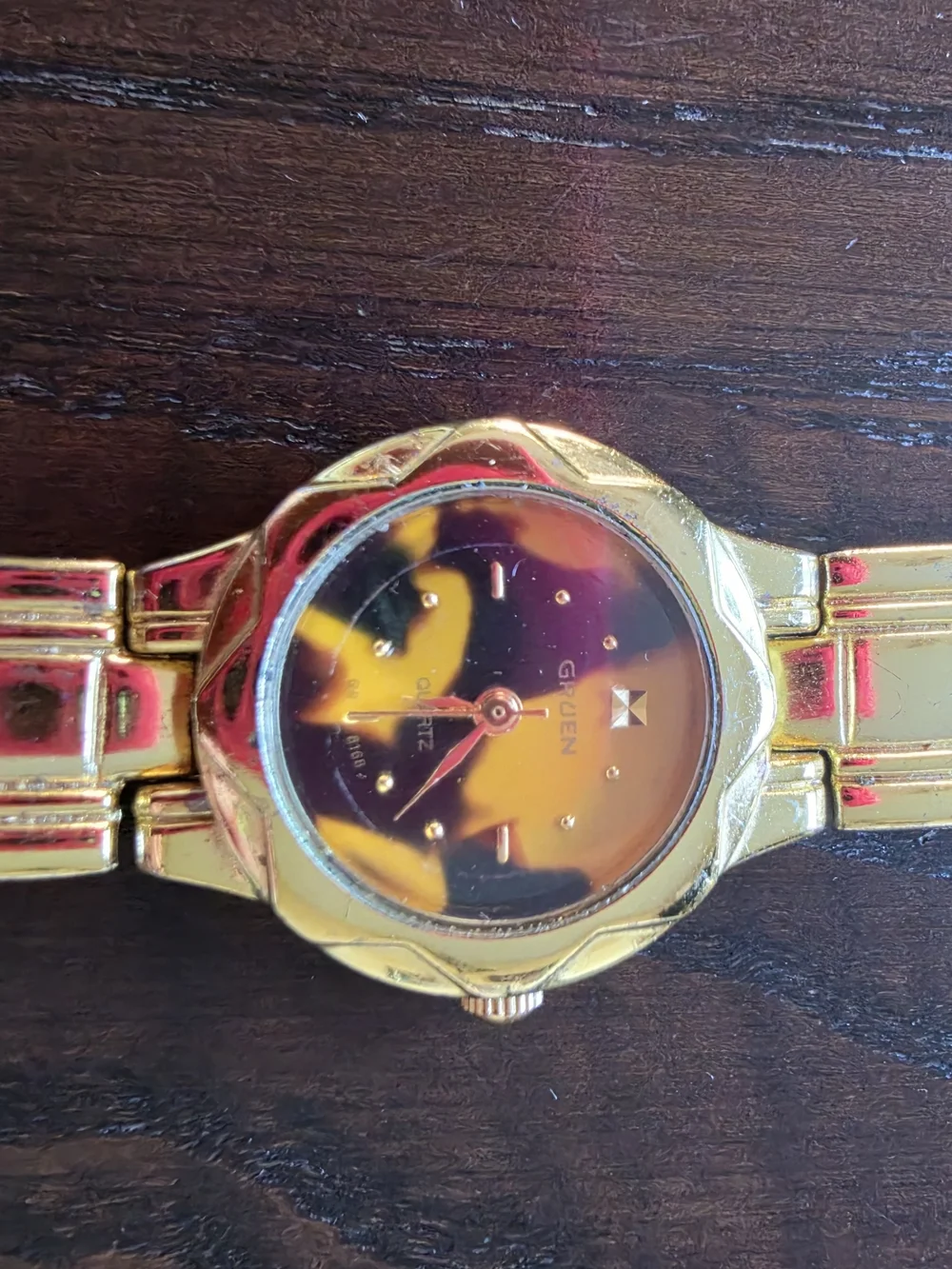 Geneva Gold Tone Women’s Watch with Black and Gold Dial